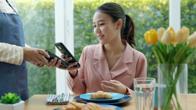 Contactless Payments Contactless payment in a restaurant.